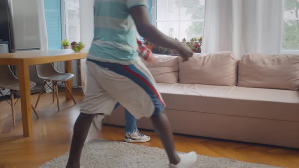 Diverse Couple in Love Communicating Relaxing on Couch at Home alt