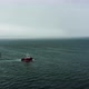 Drone Shot Tug Boat Goes to the Open Sea in Stormy Weather Behind a Cargo Ship - VideoHive Item for Sale