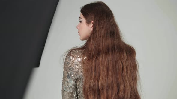 Girl in a Dress Posing in a Photo Studio