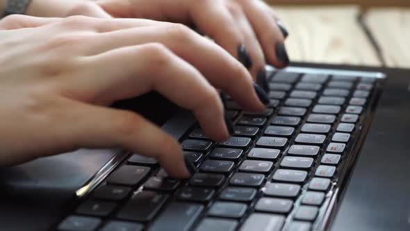 Woman hands typing on laptop keyboard