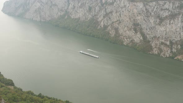 Panning on Danube river gorge and cliffs called Mali Kazan 4K 2160p 30fps UltraHD footage - Boats on alt