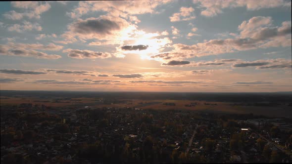 Aerial footage of drone flying towards sunset. alt
