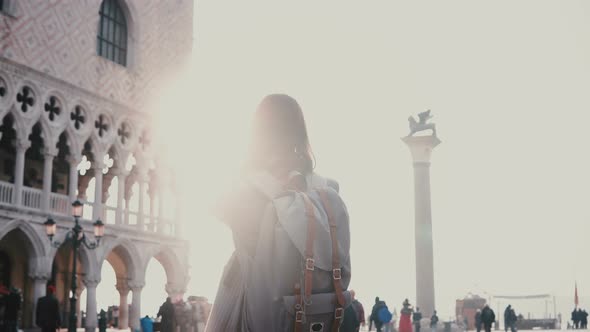 Happy Female Tourist Taking Smartphone Photos of Amazing San Marco Square in Venice, Italy alt