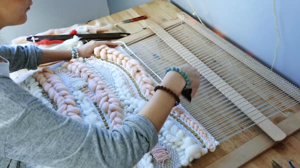 Weaving on a Loom.  Woman's Hands Running on a Loom