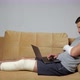 Man with Damaged Knee and Forearm Works Distantly Via Laptop - VideoHive Item for Sale