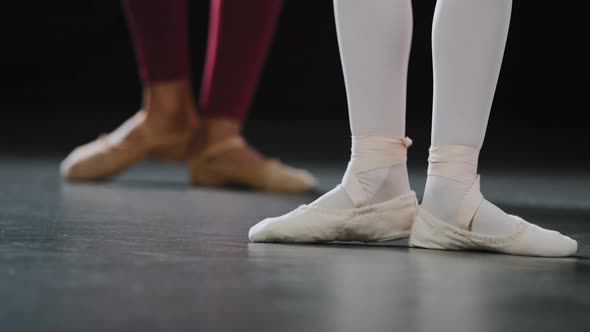 Unrecognizable Student Ballerina Repeats Movements After Teacher Spin Foot alt