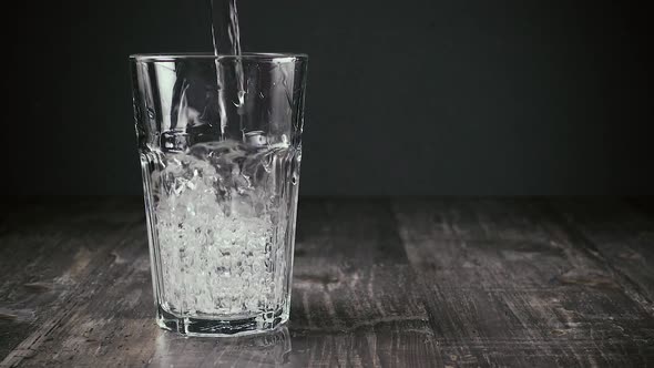 Jet of Clean Water Flows Into the Glass