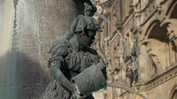 Left To Right Pan Real Time Medium Shot of the Figure of a Boy on the Famous Fish Fountain on the