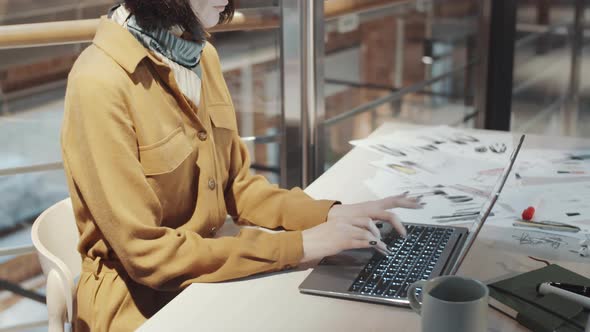 Female Fashion Designer Working on Laptop at Desk alt