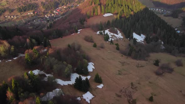 Aerial Drone View of Forest and Meadows in Spring in a Mountain Wooded Village alt