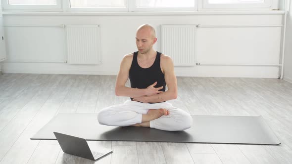 Calm Concentrated Yogi Man Showing Exercises at Laptop Camera