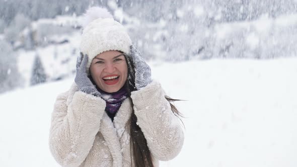 Young Woman Stands on a Balcony with a Beautiful View of the Sea and Mountains alt