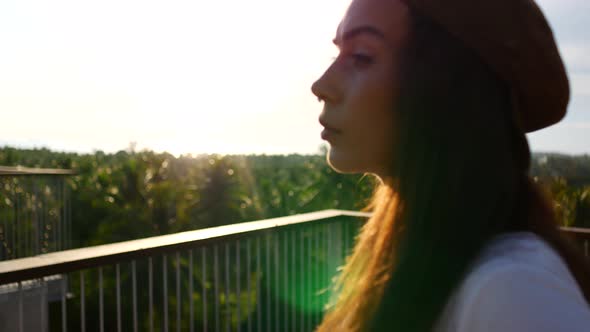 Beautiful Woman in a Beret the Sun's Rays Brightly Illuminate the Contours of Her Face and Smile alt