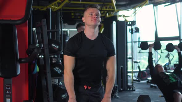 Muscular Man is Engaged in the Gym