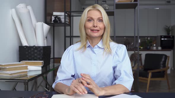 Smiling Mid Aged Woman Talking to Web Cam Giving Online Training Webinar alt