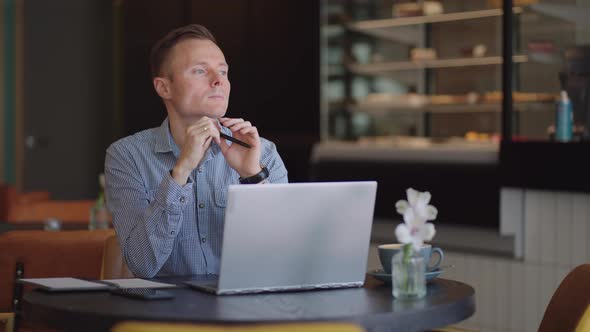 Thoughtful Serious Young Man Student Writer Sit at Home Office Desk with Laptop Thinking of alt