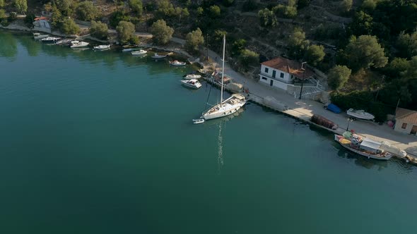 Aerial view of sailboat anchored on pier at mediterranean sea, Greece. alt