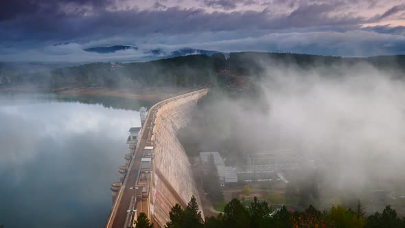 Morning Fog over Dam on Embalse de Aguilar de Campoo, Spain. alt