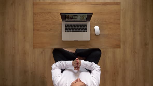 Man Meditates while Working at Computer
