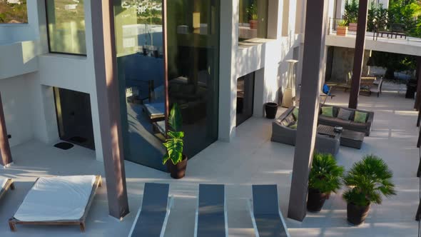 Drone Rising From Poolside To Roof Of Luxury Apartment alt