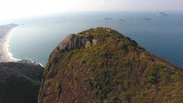 Aerial Drone Shot of Young Adults atop a Brazilian Mountain Taking in the View alt