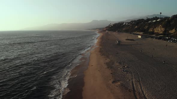 An Aerial Shot Looking Out Over a Beach as the Waves Roll onto the Beach Near Point Dume in Malibu i alt