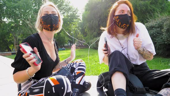 Women wearing masks listening music