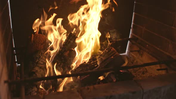 A Brightly Blazing Bonfire Burns the Blackened Firewood and the Walls of the Barbecue alt