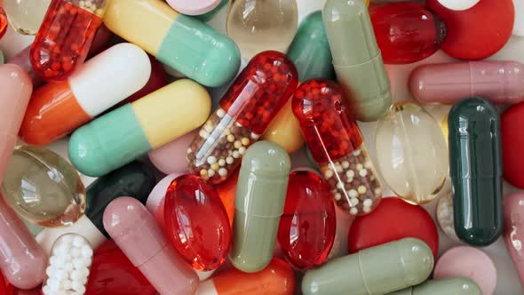 Colorful Medical Pills Oil Capsules Vitamin C Omega 3 Rotating Closeup alt