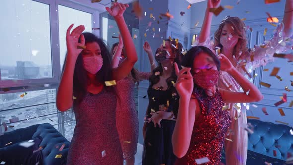 Luxury Party Beautiful Glamour Females Wearing Protective Masks Dancing in the Night Club Golden alt