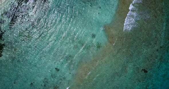 Luxury birds eye travel shot of a sunshine white sandy paradise beach and aqua blue water background alt