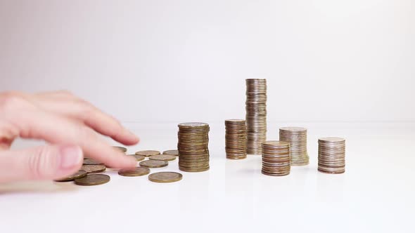 A woman's hand places coins on the table and counts them. Investment concept. Metallic currency alt