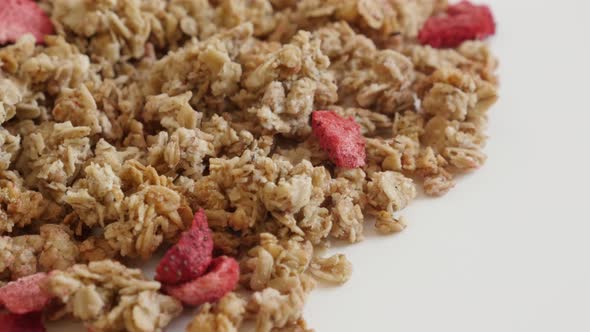 Tilting over  muesli with strawberry flavour close-up 4K 2160p 30fps UltraHD footage - Healthy dehyd alt
