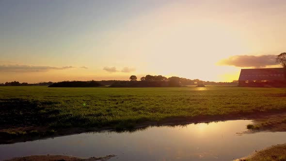Aerial Cinematic Clip Drone Flying Over a Farm Field During Sunset alt