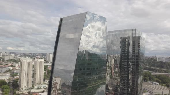 Close Mirrored two Building and Clouds with cars and river drone 4k