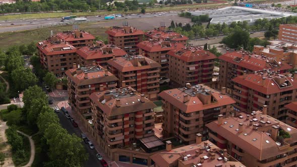Rooftops of apartment building district in Spain, aerial orbit view alt