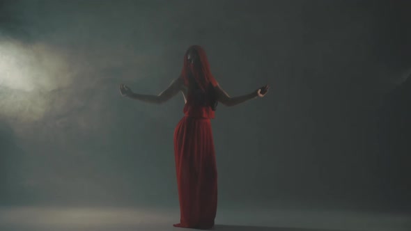 Woman Dancing in Smoke in Red Dress