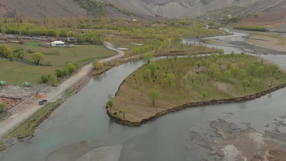 Aerial Above Ghizer River With SUV Parked On Rural Road. Follow Shot alt
