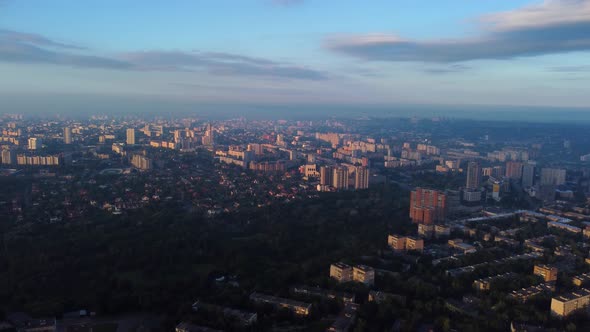 Aerial sunrise in city with epic clouds, sun shine