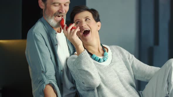 Aged Couple Sitting in the Kitchen alt