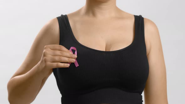 Caucasian Woman in a Black Seamless Bra Put Pink Ribbon for Breast Cancer
