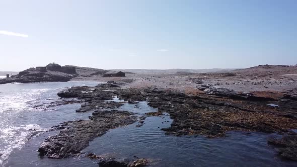 Drone footage of the beautiful rocky island with unique black footed penguins alt