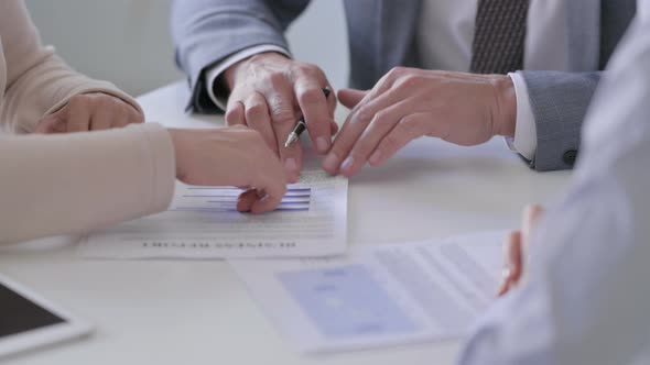 Close up of Hands of Businessman with Female Colleagues Discussing Documents alt