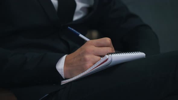 Businessman Taking Notes in Notepad Close Up