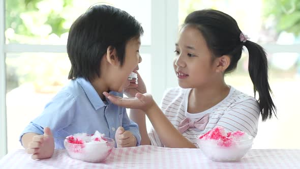 Happy Little Asian Children  Eating Ice Cream At Home alt