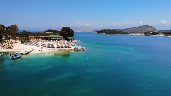 Aerial View of a White Sandy Beach with Many Sun Loungers Without People on a Sunny Day on the