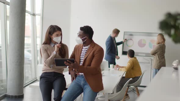 Group of young multiethnic business people working together with facial protection masks