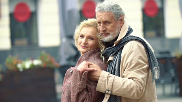 Aged Couple Walking on the Street alt