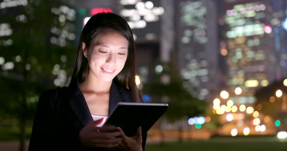 Businesswoman use of tablet computer at night alt