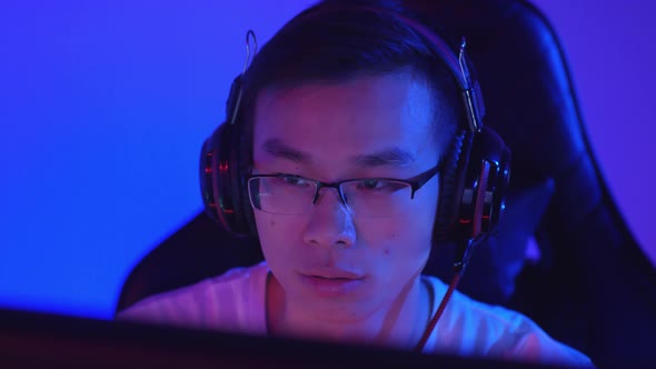 Asian Teenager Having Victory in Online Shooter alt